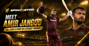Cricketer Amir Jangoo raising his helmet in West Indies kit, with Spin24Star logo and text "Meet Amir Jangoo: Age, Stats & Story of a Steady Finisher."